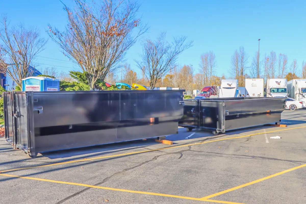 Professional dumpster rental service with roll-off container on residential driveway in Collegedale